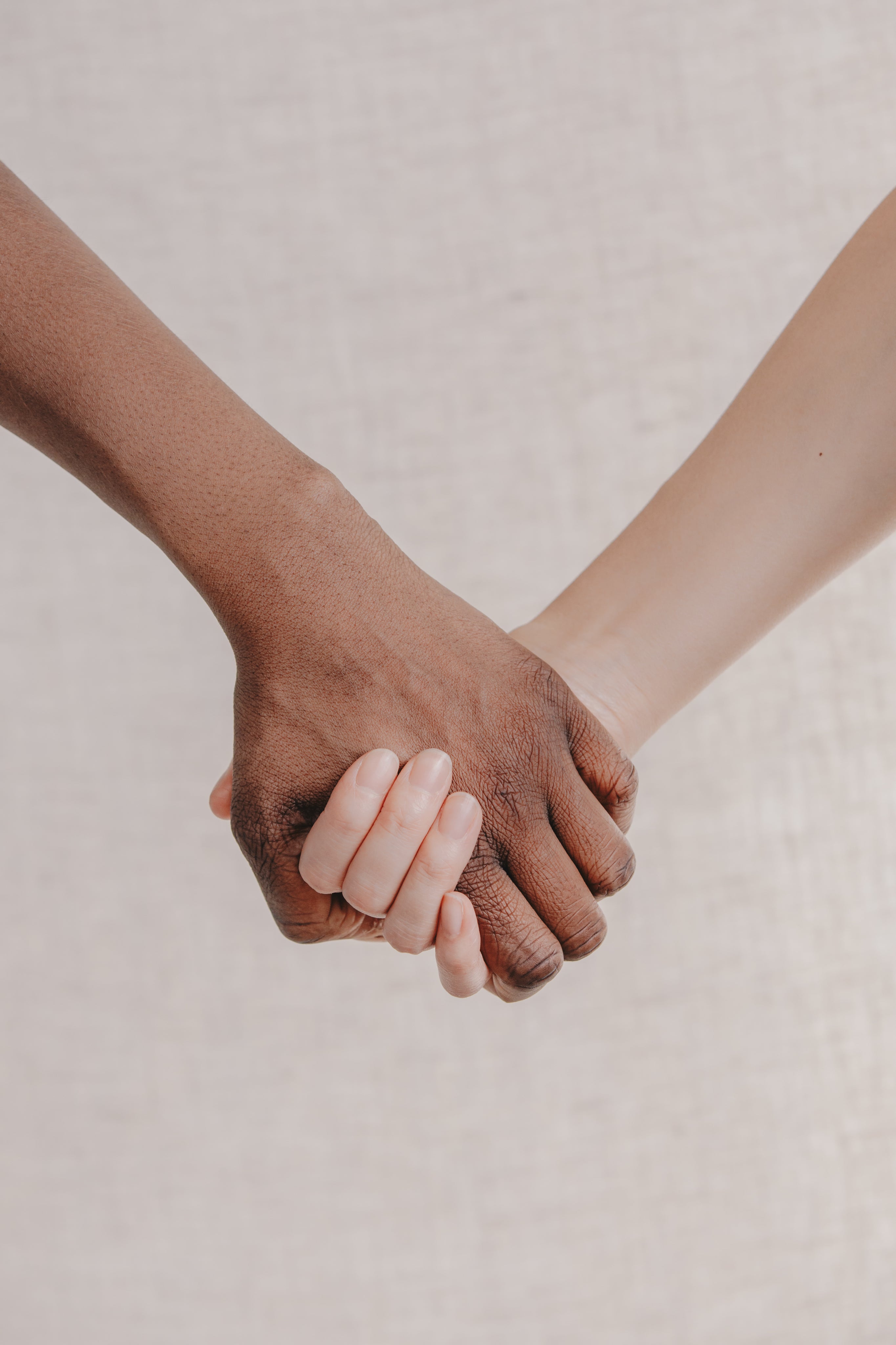 a-close-up-two-people-holding-hands-together.jpg