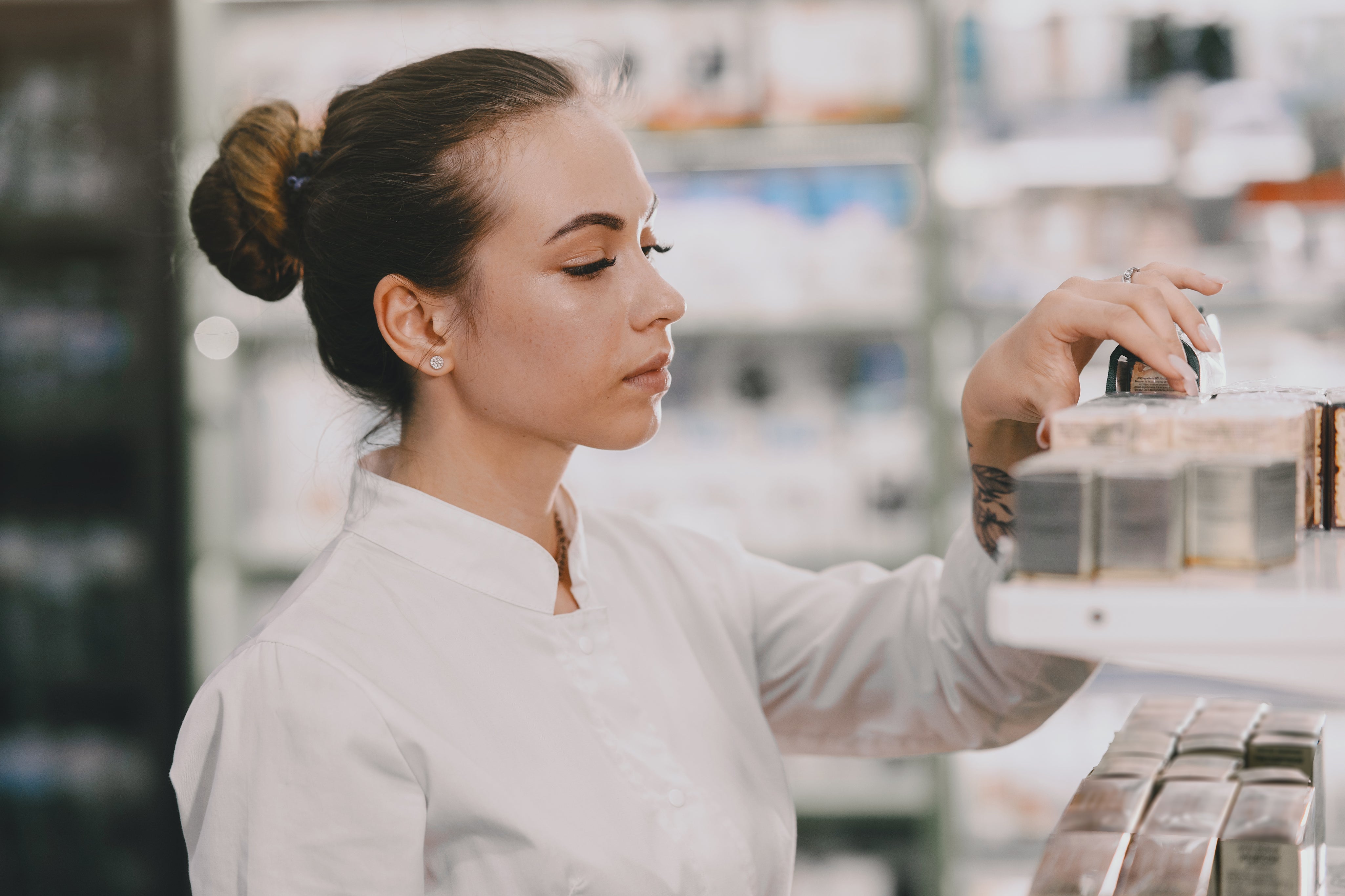 medicine-pharmaceutics-health-care-people-concept-female-pharmacist-taking-medications-from-shelf.jpg